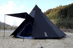 a blue tent sitting on top of a sandy beach