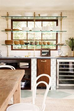 the kitchen is clean and ready to be used for cooking or baking, while also being used as a dining area