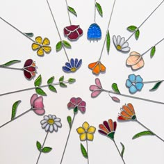 a group of colorful flowers sitting on top of a white table