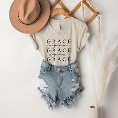 "Out of his fullness we have all received grace in place of grace already given. - John 1:16 This T-shirt made at Naptime is an awesome way to spread the love of Jesus! This essential short sleeve t shirt fits like a well-loved favorite, featuring an irresistibly soft poly cotton blend and V neck. * Lightweight and comfy womens fit, most ladies tell us they run \"true to size\". * Lightweight and breathable tri-blend material, with a straight hem perfect for tucking or tieing. * Designed by Mich Christian Jewelry Necklaces, Christian Outfits, John 1 16, Grace Upon Grace, Essential Oil Roller Bottle, Shirt Fits, Short Sleeve T Shirt, Christian Clothing, Nap Time