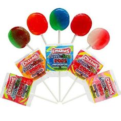 six lollipops on a stick with gummy's candies in them