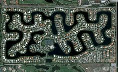 an aerial view of a city with lots of buildings and trees in the middle of it