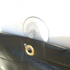 an open black purse with a gold ring on it