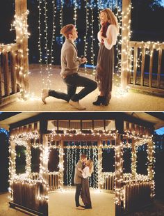 a man kneeling down next to a woman in front of a building with christmas lights