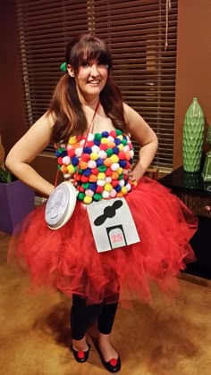 a woman in a red tutu skirt holding a bunch of candies on her chest