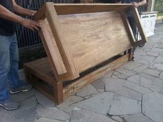 two men standing next to each other near a large wooden box on the ground,