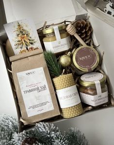 a christmas gift box filled with candles, cookies and other holiday treats for the holidays