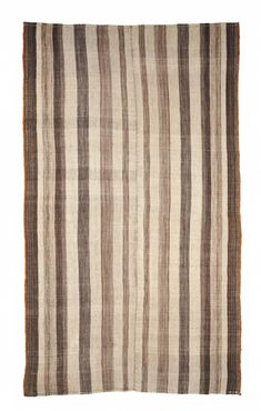 a brown and white striped rug on a white background