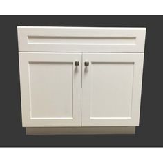 a white cabinet with two doors and one drawer on the front, against a black background