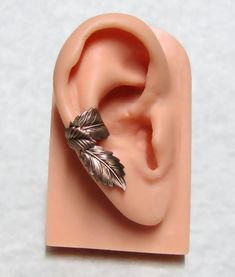 a fake ear with a leaf on it