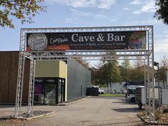 a sign that says cave and bar in front of a building