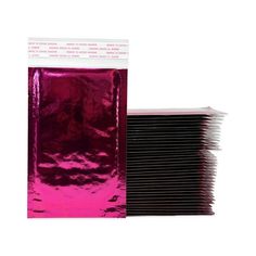 pink foil bags are stacked on top of each other in front of a white background