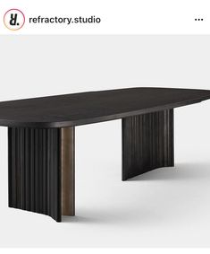 a black table sitting on top of a white floor next to a gray wall with the words refacty studio above it