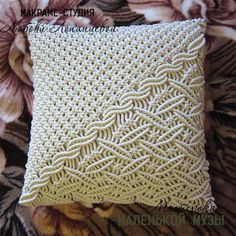 a close up of a pillow on top of a floral print bed sheet with the words machine crochet written across it