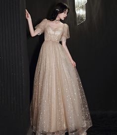 A-line Tulle Evening Dress For Homecoming, Floor-length Tulle Ball Gown For Banquet, Champagne Tulle Prom Gown, A-line Tulle Gown For Prom, A-line Tulle Ball Gown For Prom Season, A-line Tulle Maxi Dress For Prom Season, Tulle Maxi Dress For Banquet, Tulle Maxi Dress For Banquets, Champagne Floor-length Evening Dress For Debutante Ball