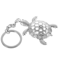 a key chain with a turtle on it's back and a ring in the middle