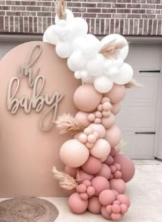 there is a cake with balloons on it and the words oh baby spelled in large letters