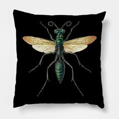 a black pillow with a green and yellow insect on it