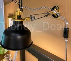 a black lamp hanging from the side of a wall