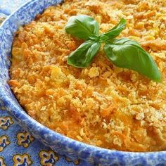 a casserole dish with cheese and basil garnish