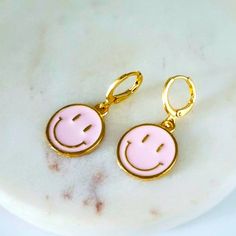 Pink Round Smiley Face Earrings. Huggies Earrings, Material Zinc Alloy And Enamel. 1.25 Length .4 Width Cute Handmade Pink Hoop Earrings, Dainty Pink Drop Earrings, Playful Pink Hoop Earrings Gift, Playful Pink Round Earrings, Cute Pink Hoop Earrings For Gift, Pink Playful Handmade Hoop Earrings, Dainty Pink Nickel-free Jewelry, Dainty Nickel-free Pink Jewelry, Trendy Pink Dangle Jewelry