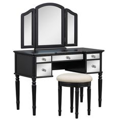 a black and white vanity with mirror, stool and stool on the bottom shelf in front of it