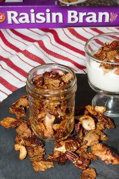 two jars filled with granola sitting on top of a table