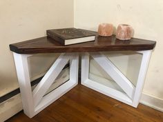 a table with two books on top of it and some vases next to it