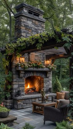 an outdoor fireplace surrounded by greenery and furniture