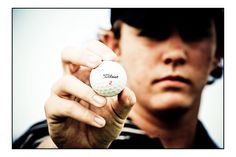 a man holding a golf ball in his hand