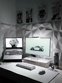 two computer monitors sitting on top of a desk next to a keyboard and monitor screen