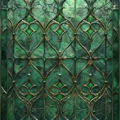 an ornate glass window with green and gold designs