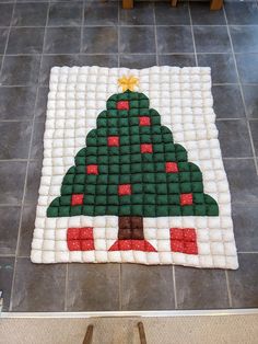 a christmas tree made out of legos on the floor