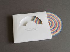 a white box with some colorful paper on top of it and a circular object in the middle