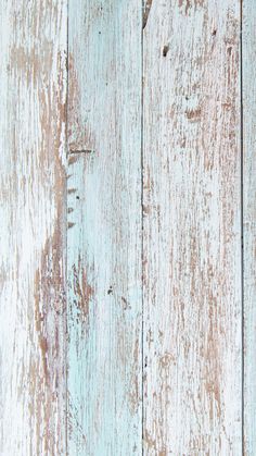 an old white painted wooden wall with peeling paint and chipped paint on it's sides