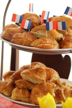 two tiered trays filled with pastries and flowers