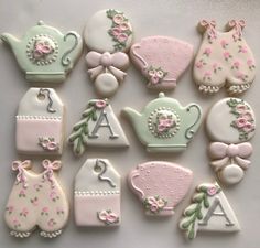 decorated cookies are arranged in the shape of teapots, kettles and other items