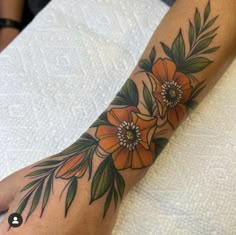 a woman's foot with flowers on it