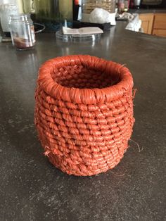 an orange basket sitting on top of a counter