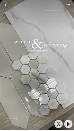 the back side of a white marble tile with hexagonal tiles on it and an advertise that reads, warm & welcoming