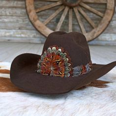 The Rowan Western Feather Hat Band, Short, is specially crafted for smaller-sized hats (6 7/8 and under) and kids' hats. Made from 100% feather, it has an approximate length of 53 cm (excluding leather ties) and a width of 2 cm. The crest measures 4" W x 3.25" H, adding a distinctive and elegant touch to the design. Adjustable with leather ties, this hat band ensures a secure fit while providing a stylish western accent for smaller hats. Adjustable Brown Mini Hat With Short Brim, Brown Adjustable Mini Hat With Short Brim, Adjustable Brown Mini Hat With Flat Brim, Rustic Adjustable Brown Top Hat, Adjustable Brown Hat For Kentucky Derby, Brown Curved Brim Hat Bands For Kentucky Derby, Brown Adjustable Hat For Kentucky Derby, Brown Curved Brim Top Hat For Ranch, Brown Adjustable Mini Hat With Curved Brim