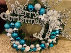 a christmas wreath with blue and silver ornaments