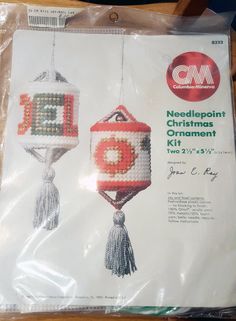 an ornament kit for needlepoint christmas ornaments in the shape of lanterns with tassels