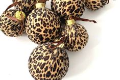 several leopard print ornaments are arranged on a white surface