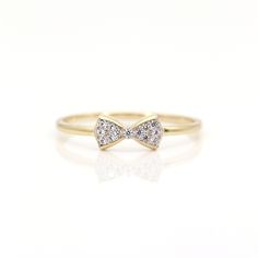 a diamond bow ring on a white background