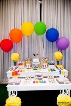 a baby shower party with balloons and cake