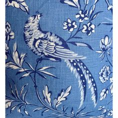 a blue and white pillow with a bird on it's back side, surrounded by flowers