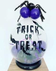 there is a trick or treat decoration in the shape of a ball with bats on it