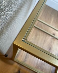 a mirror sitting on top of a wooden floor next to a white bed sheet and pillow