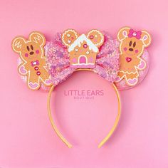 a pink and gold minnie mouse ears with gingerbread cookies on it's ears